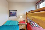Mill Creek guest room with full bed and twin bunks